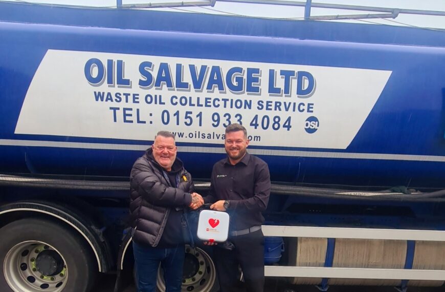 Mark King from the Oliver King Association issuing a defibrillator to our Compliance Manager Neil