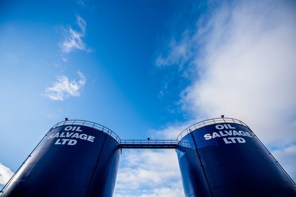 Oil Salvage's tanks against a blue sky